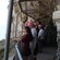 A group of people in hard hats standing outside a mountain cave looking out to the sea